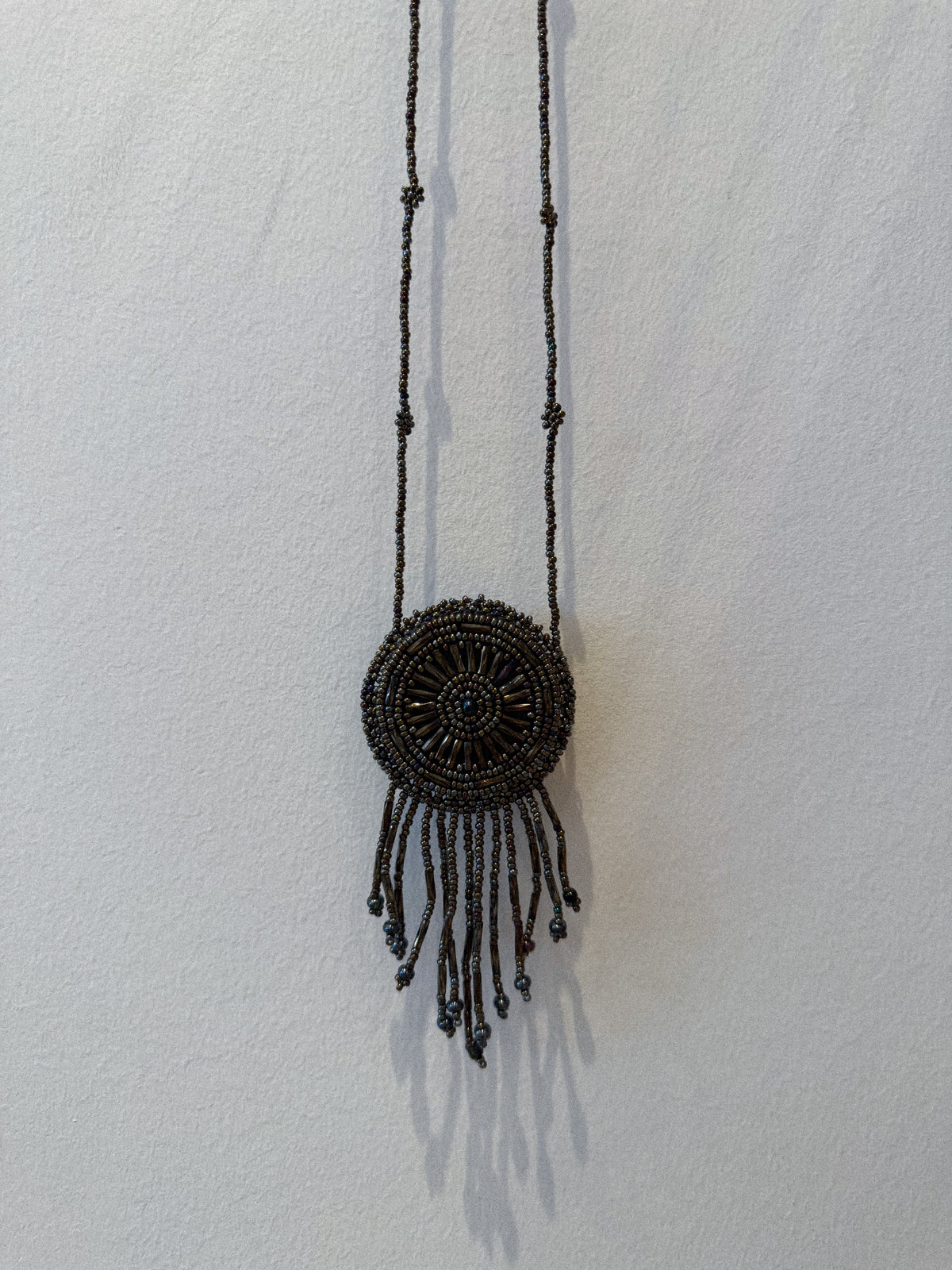 BEADED MEDALLION NECKLACE IN METALLIC GUNMETAL